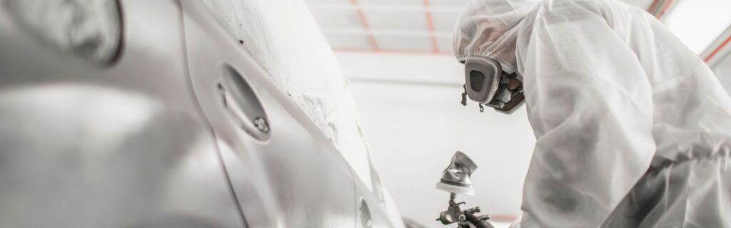 Painting car in a spray booth